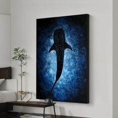 a painting of a whale is hanging on the wall