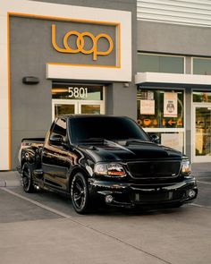 a black truck parked in front of a building