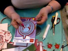 a woman is making some cards with scissors