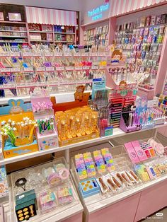 there are many items on the shelves in this store that is pink and white with stripes