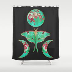 a shower curtain with an image of a butterfly on it's back and the moon behind it