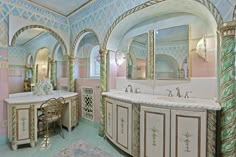 an ornate bathroom with pink walls and gold trim