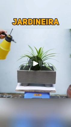 a person is using a drill to fix a potted plant