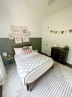 a bed room with a neatly made bed and two nightstands on either side of the bed