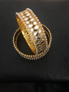 It's time you level up your jewelry box! Add in some bling to with our royal handmade kundan bangles! Style with love and care! We put in so much effort in what we do,because we do it for YOU❤️ Made to order and shipping time 4-6 weeks Can be make as a pair or single too. Each bangle price : $20 Gold Jewelry With Mirror Work For Gift, Kundan Bracelets With Intricate Design For Celebration, Gift Gold Kundan Necklace With Mirror Work, Gold Kundan Necklace With Mirror Work For Gift, Elegant Ceremonial Jewelry With Mirror Work, Traditional Gold Plated Bangle For Celebrations, Gold Chandbalis With Mirror Work For Diwali, Celebration Gold-plated Hand-set Bangle, Kundan Jewelry With Mirror Work