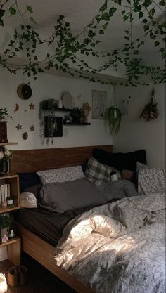 an unmade bed in a room with plants growing on the walls and ceiling above it