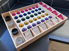 a wooden tray filled with lots of different types of candies on top of a counter