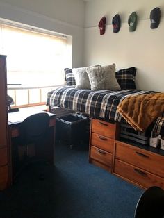 a bed room with a neatly made bed and desk