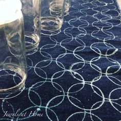 the table cloth has circles on it and is blue with white lines in between them