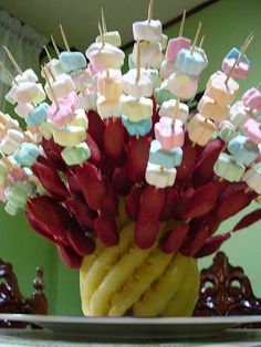 a vase filled with marshmallows on top of a table