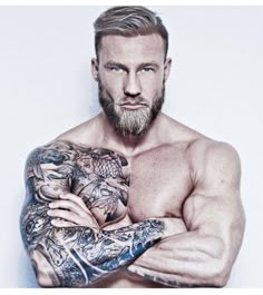 a man with tattoos on his arms and chest