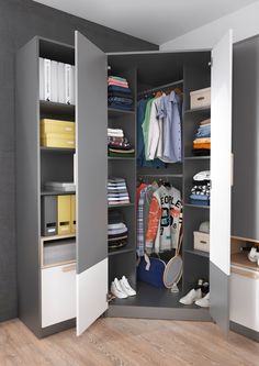 an open closet with clothes and shoes in it