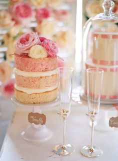 there is a wedding cake and champagne glasses on the table