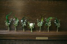 flowers are arranged in rows on the piano