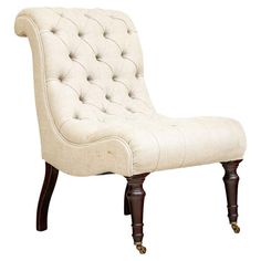 a white chair with wooden legs and buttons