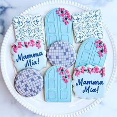 decorated cookies on a plate with the names mamma mia, mama mia and door