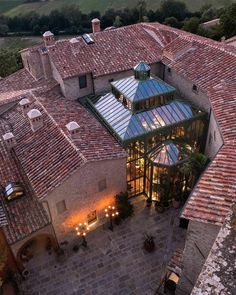 an aerial view of a building with many lights on it's roof and windows