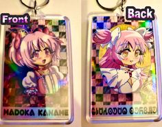 two keychains with anime characters on them, one in pink and the other in white