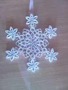 a white snowflake sitting on top of a wooden table