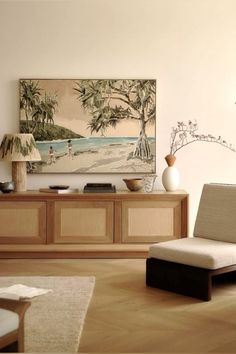 a living room filled with furniture and a painting on the wall