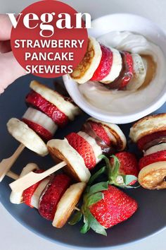 a plate with strawberries and bananas on skewers