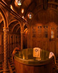 a large bath tub sitting inside of a bathroom next to a wooden wall and ceiling