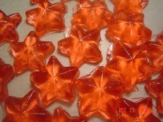 small orange glass flowers on a white surface