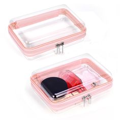 two clear cases with various items in them on a white surface, one is empty and the other has a black lid