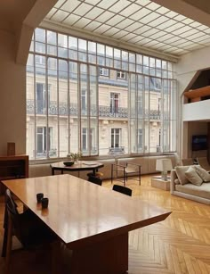 a living room with wooden floors and large windows