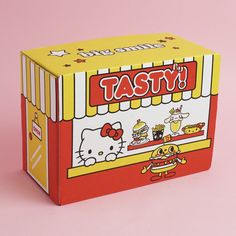 a hello kitty take out box sitting on top of a pink surface with the words tasty written in it