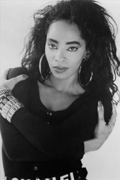 a black and white photo of a woman with big hoop earrings