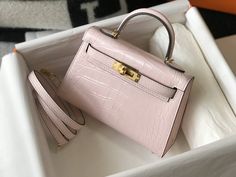 Description HRMS Mini Kelly 19 Embossed Patent Pink Matte Bag With Gold-Toned Harware For Women, Handbags, Shoulder Bags 7.5in/19cm Rep 1:1 Size: 19 x 15 x 16 cm / 7.5 x 6 x 6.2 inches (Length x Height x Width) Dating back to 1989, this rare dainty-sized Hermès Kelly is a much-coveted vintage piece unmatched in elegance. The petite bag is in a good vintage shape. Hermès bags are considered the ultimate luxury item worldwide. Each piece is handcrafted with waitlists that can exceed a year or more. Pink Mini compartment Gold-toned hardware Interior with 1 side zippered pocket A protective footed bottom Handle: Single Adjustable shoulder strap Includes box, dust bag. This product is of the best quality. The production time is 15-20 working days. If you want to custom your own bag, please cont Mini Kelly, Luxury Bags Collection, Hermes Kelly Bag, Kelly Bag, Pink Mini, Hermes Bags, Evening Clutch Bag, Hermes Bag, Tote Backpack