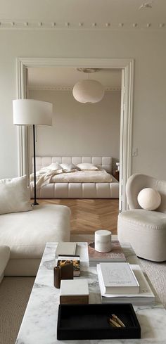 a living room filled with furniture and a large mirror