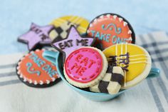 some decorated cookies in a bowl on a table