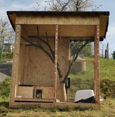 a chicken coop with a tree painted on it