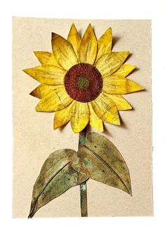 a yellow sunflower with green leaves on a piece of paper