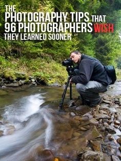 a man is taking pictures in the water with a camera and tripod on his knees