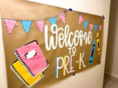 a welcome to pre - k sign on the side of a wall in a classroom