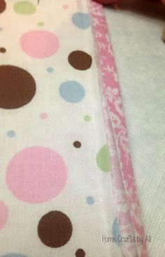 a close up of a pink and brown polka dot print fabric on a table cloth