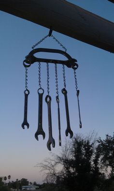 a bunch of wrenches hanging from a chain