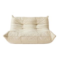 a white futon couch sitting on top of a white floor