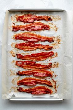 bacon strips on a baking sheet ready to be cooked in the oven or baked in an oven