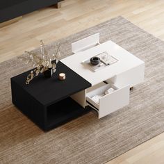 a white and black coffee table sitting on top of a carpeted floor next to a rug