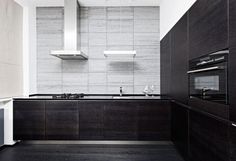 modern kitchen with black cabinets and white walls