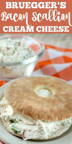 a bagel sandwich on a plate with cream cheese in the background and text overlay