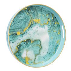 a blue bowl with yellow and white paint on it's side, in front of a white background