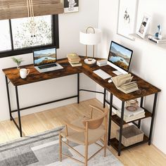 an open laptop computer sitting on top of a wooden desk next to a chair and lamp