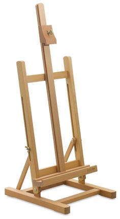 a wooden easel sitting on top of a white floor