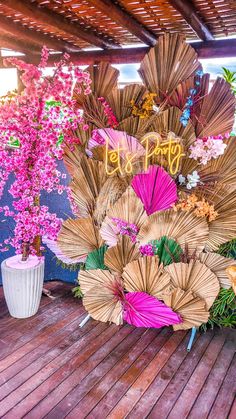 an arrangement of umbrellas and flowers on a deck