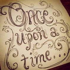 a piece of paper with the words once upon a time written in cursive writing